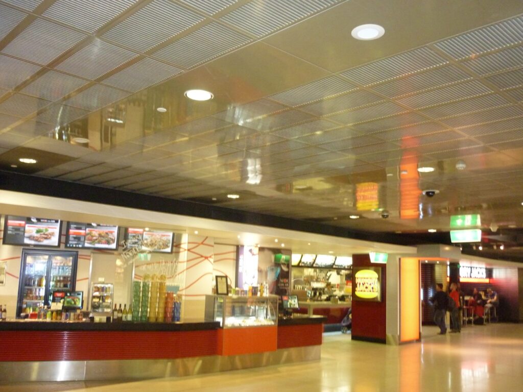 Retail food court featuring Murano grooved timber acoustic ceiling panels integrated into a commercial hospitality environment.