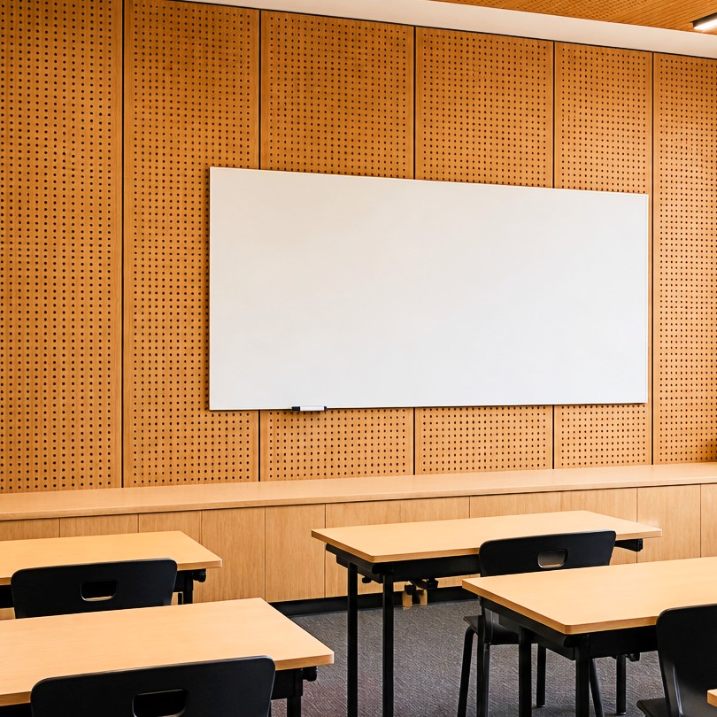 Modern classroom featuring Murano perforated timber acoustic wall and ceiling panels with slotted timber acoustic wall panels for improved learning acoustics
