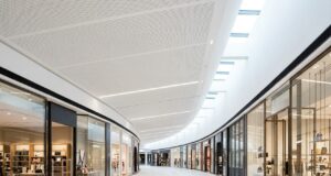 Curved shopping centre concourse featuring Murano perforated timber acoustic ceiling panels and premium retail tenancies